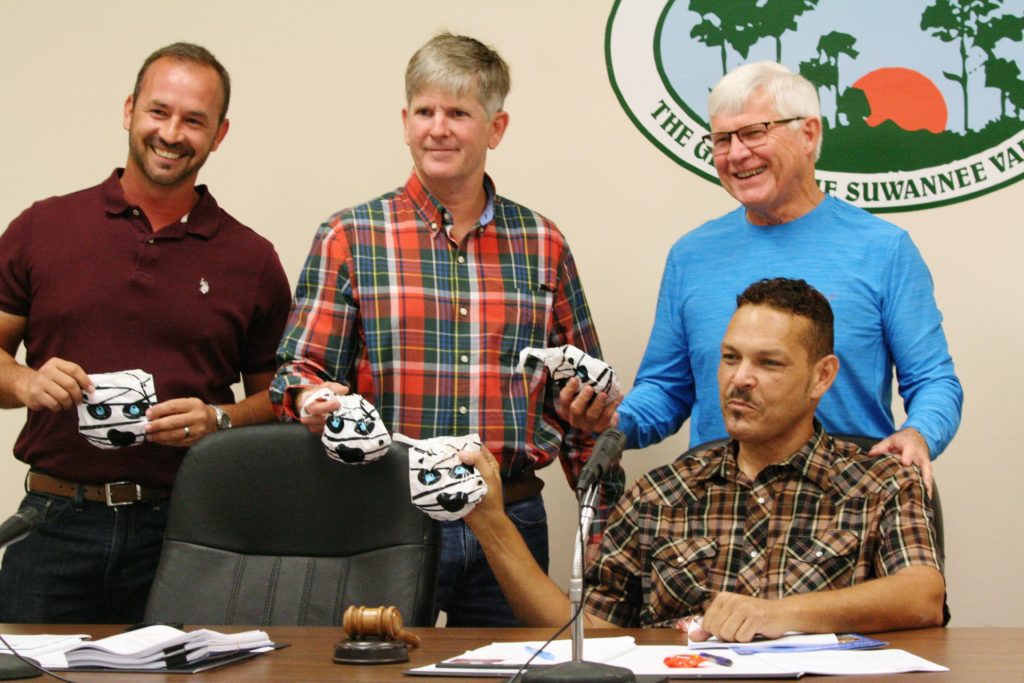 Commissioners Tim West. Rolling Hudson, Norman Weaver and Mayor Chris Jones show off their Halloween treats they received as a gift from a city employee who likes to give sweet treats.