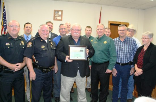 Retired Williston Deputy Police Chief Clay Connolly is honored at Tuesday's Levy County Commission meeting