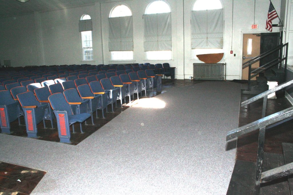 The former BHS auditorium will convert to the county commission meeting chambers. The stage will be walled off and a short platform will be constructed in the area shown in front of the first row of seats to hold the board's meeting desk, or dais.