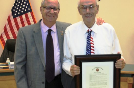 Williston Mayor Jerry Robinson presents Mayor Emeritus Gerald Hethcoat with a framed resolution celebrating his 31 years of public service to the city.