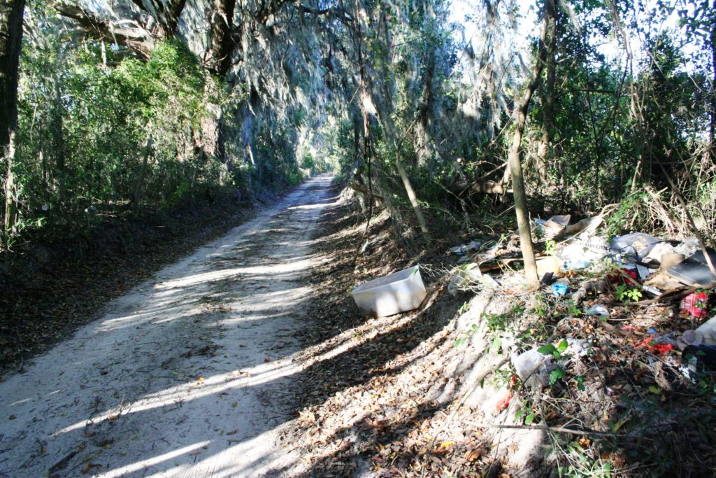 An illegal dump site on NW 40th Ave. clutters private property along the one lane road near Chiefland. This half mile section was closed to the public Tuesday by county commissioners.