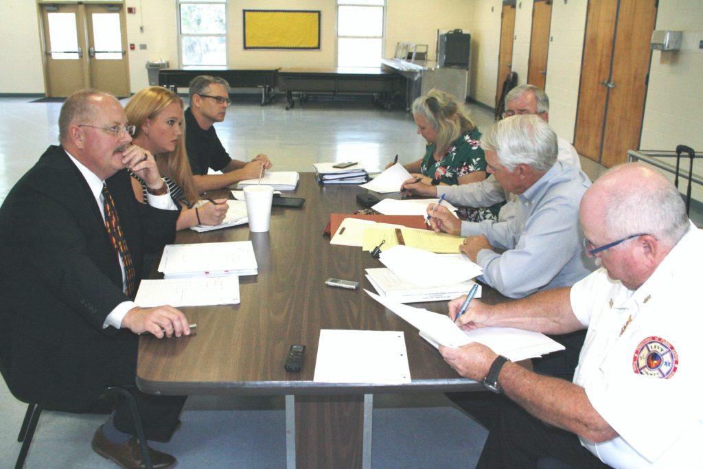 International Association of Firefighters Local 4069 representatives including attorney James F. Brantley, IAFF Local 4069 President Katy Graves and Vice President Chris Castleberry on the left negotiate with county Human Resources Director Jacqueline Martin, County Coordinator Wilbur Dean, attorney Wayne Helsby and Public Safety Director Mitch Harrell