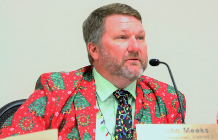 Outgoing County Commission Chairman John Meeks is dressed in holiday attire as he discusses adjustment board.