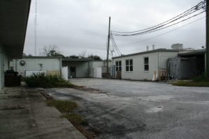 The rear of the hospital looks dreary under overcast skies.