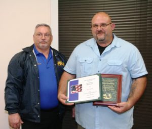 Police Chief Scott Anderson recognizes retiring Capt. Ray Tremblay with a plaque and certificate.