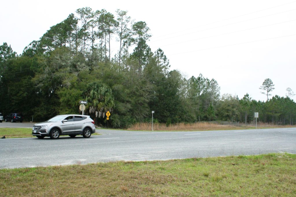 The new Bronson fire house is to be constructed on this forested piece of property adjoining the Levy County Agriculture Center parking lot. The Ag center is connected to town water and sewer. The lines will be extended next door to the fire house. Photo by Terry Witt.