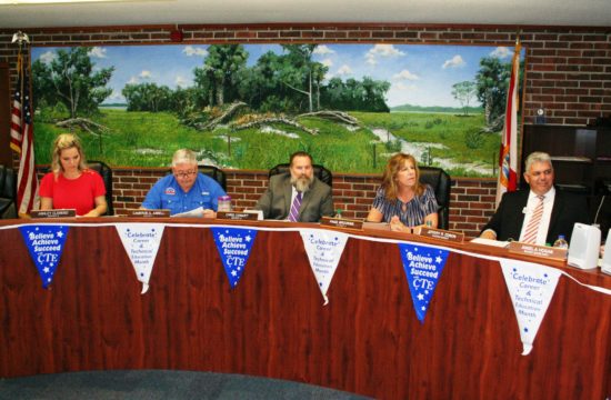 Levy County School Board members Ashley Clemenzi, Cameron Asbell, Chris Cowart and Chairwoman Paige Brookins along with Superintendent Jeff Edison prepare for the start of their board meeting with a light business agenda.