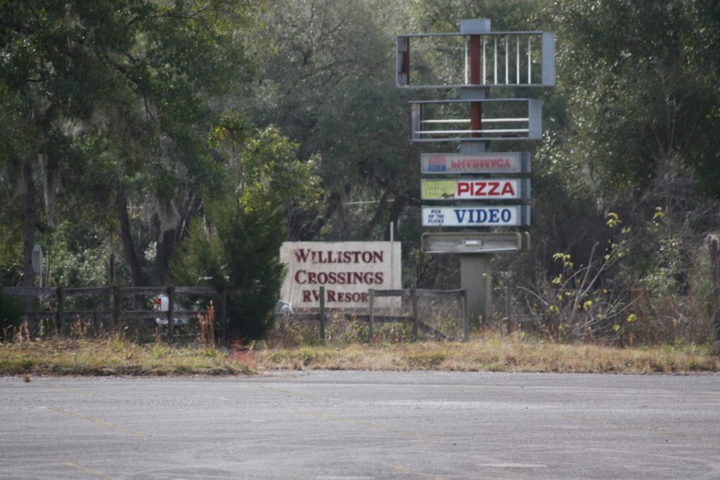 This shot of the former highway sign for the old Winn Dixie illustrates the deplorable condition of the vacant shopping center.