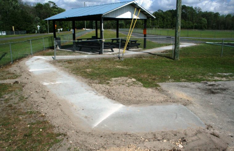 The new handicapped accessible sidewalk at James H. Cobb Park connects the parking lot to the pavilion and track.