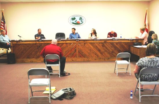 Visitors to the Chiefland City Commission sat six feet apart in six chairs to prevent transmission of the Covid-19 virus. It was a sign of the times.