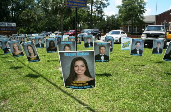 Chiefland High School senior class photos are displayed in front of the school to honor the students. Valedictorian Reagan Hudson and Salutatorian Alana Hord to her left lead the class academically.