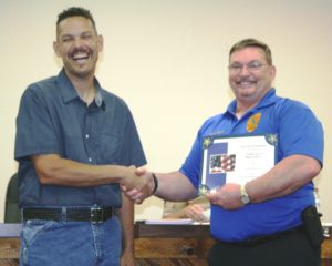 Chiefland Police Chief Scott Anderson accepts his five-year certificate from Mayor Chris Jones.