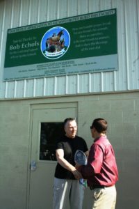 Levy County Commission Chairman Matt Brooks honors Bob Echols with a plaque for his $290,000 donation that built the new facility.