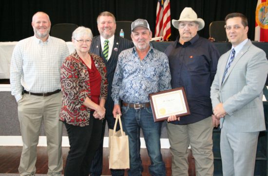 . Levy County Commissioners Rock Meeks, Lilly Rooks, John Meeks, Mike Joyner and Commission Chairman Matt Brooks honor retiring Road Superintendent for his loyalty and dedication to the county.