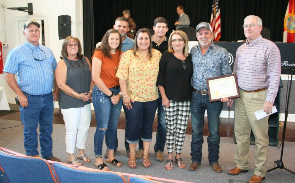 Road Superintendent Kelly Jerrels and his wife Debbie are joined by other family members and County Coordinator Wilbur Dean (right) for the retirement ceremony.