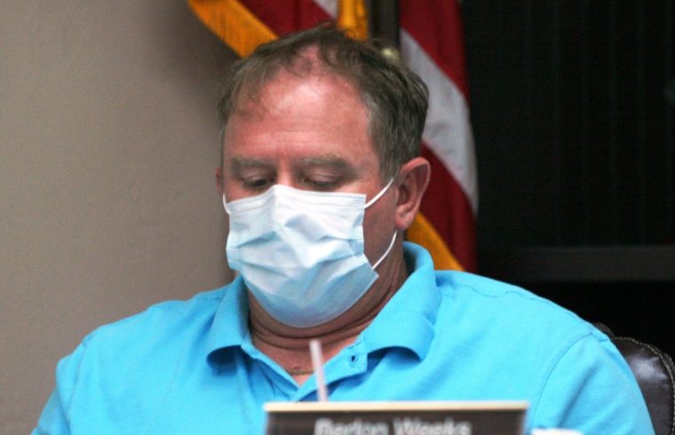 Bronson Councilman Berlon Weeks, wearing a face mask spoke Tuesday night about the need to halt stop-sign running at the intersection of County Road 32 and 337.