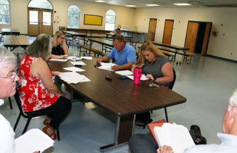 County Coordinator Wilbur Dean and County Labor Attorney Wayne Helsby chat during union negotiations Tuesday. Seated at the table on the left is County Human Resources Director Jacqueline Martin and at the end Alesha Rinaudo of the Department of Public Safety. On right are EMT Jimmy Jones and IAFF President Katy Graves.