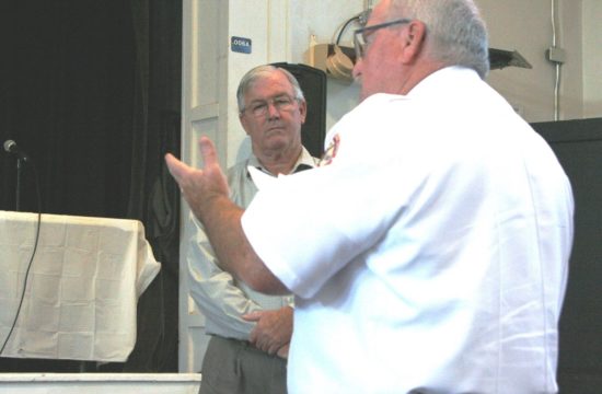 County Public Safety Director Mitch Harrell discusses the EMS assessment as County Coordinator Wilbur Dean listens in the background.