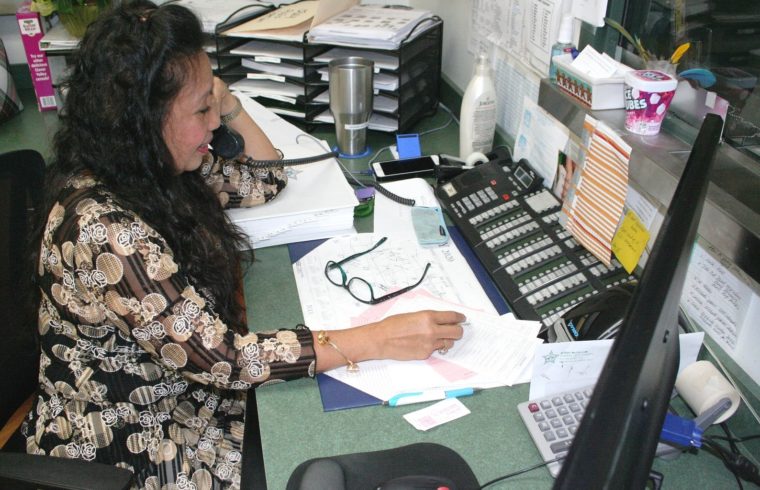 Donna Gilbert operates the control panel where non-emergency phone calls arrive during regular business hours at the Levy County Sheriff's Office. The phone lines were being manipulated by a hacker starting Thursday morning.