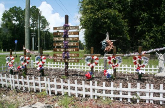 The memorial to five children and their bus driver who died 33 years ago in a school bus accident is fenced and decorated with red, white and blue at the intersection of County Road 32 and 337.