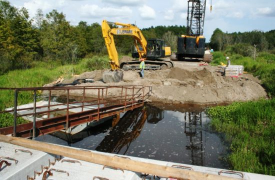 A private bridge construction crew works on the final span of the new Waccasassa River flats bridge near Bronson. The bridge is surrounded on both sides by a massive wetlands area feeding the river with water.