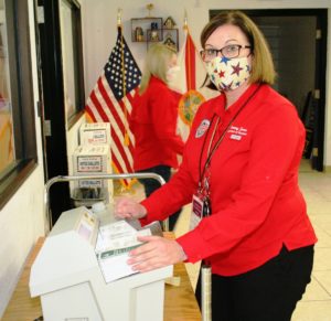 Supervisor of Elections Tammy Jones opens ballots with a new electronic device. This was the first election where the electronic opener was used.