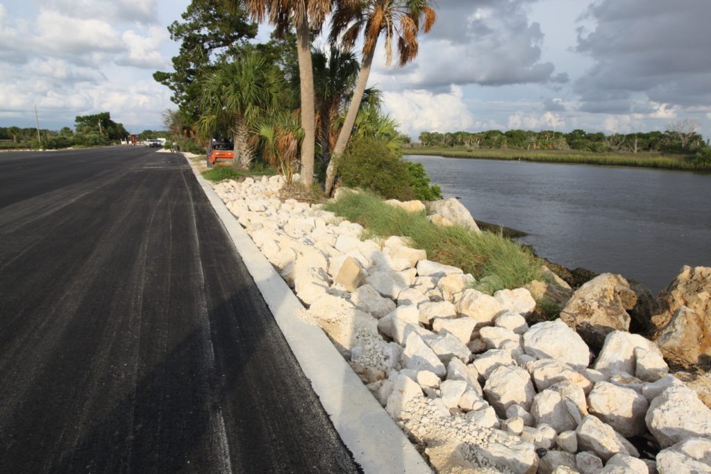 The parking lot of Bird Creek Boat Ramp shows the Withlacoochee River on one side and the parking lot on the left. The parking lot will be striped for parking.