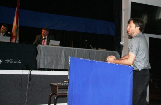 Dave Pieklik, the county's economic development director, was silenced by County Attorney Anne Bast Brown while discussing a planned solar farm for the Chiefland area. Listening are Commission Chairman Matt Brooks and Commissioner John Meeks. Commissioner Mike Joyner was absent. He normally sits on the far right.