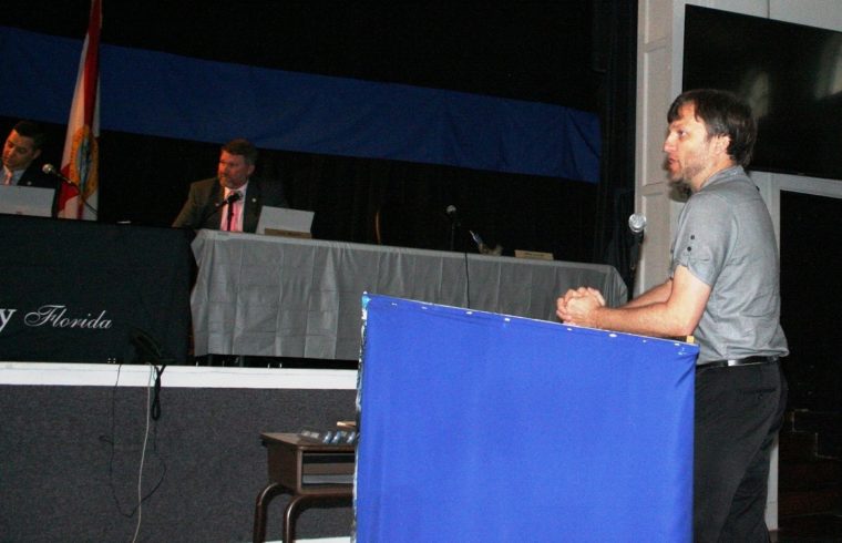 Dave Pieklik, the county's economic development director, was silenced by County Attorney Anne Bast Brown while discussing a planned solar farm for the Chiefland area. Listening are Commission Chairman Matt Brooks and Commissioner John Meeks. Commissioner Mike Joyner was absent. He normally sits on the far right.