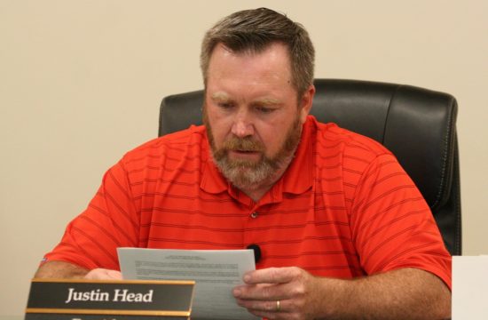 Williston Council President Justin Head reads from a resolution calling for the vacant position on the council to be advertised and filled by council appointment.