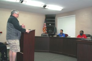 Bronson businessman Cameron Asbell tells Councilman Jason Hunt and Mayor Beatrice Roberts that he didn't get good cooperation from the town when he first complained about his sewer problem. The council agreed to reimburse Asbell for his plumber bill and repair his grant-funded sewer line. Roberts apologized.