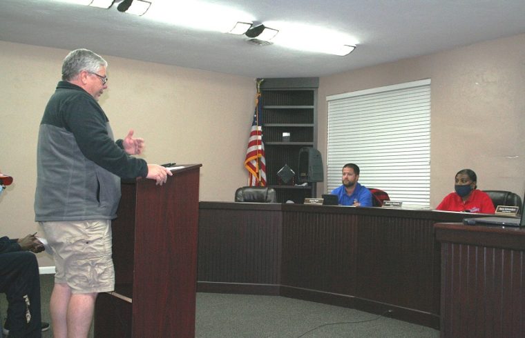 Bronson businessman Cameron Asbell tells Councilman Jason Hunt and Mayor Beatrice Roberts that he didn't get good cooperation from the town when he first complained about his sewer problem. The council agreed to reimburse Asbell for his plumber bill and repair his grant-funded sewer line. Roberts apologized.