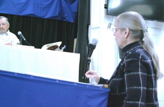 County Attorney Anne Bast Brown requests a 3 percent pay raise as County Commissioner Mike Joyner listens. Joyner was the only board member to vote against the raise