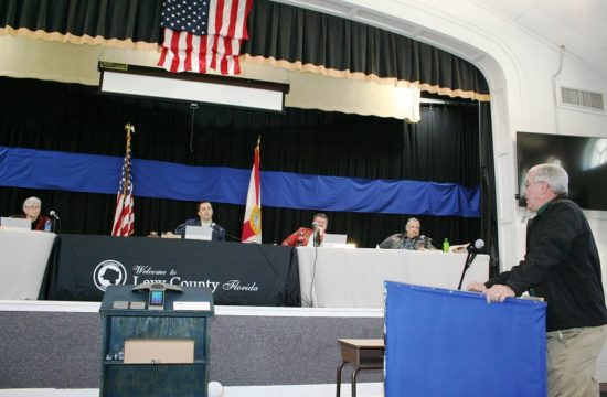 County Coordinator Wilbur Dean tells Commissioner Lilly Rooks, Commission Chairman Matt Brooks, Commissioner John Meeks, and Commissioner Mike Joyner he is crafting a policy that describes an unwritten pay raise practice that has gone on for years. Not pictured is Commissioner Rock Meeks, John Meeks was chosen as chairman and Joyner as vice-chairman in the meeting. Meeks voted against his appointment to the chairmanship.