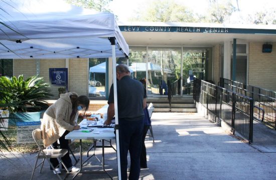 A Levy County couple registers for their COVID-19 vaccination Tuesday afternoon. Sixty people had received the shot by the time this shot was taken at the front of the Levy County Department of Health on Main Street in Bronson.