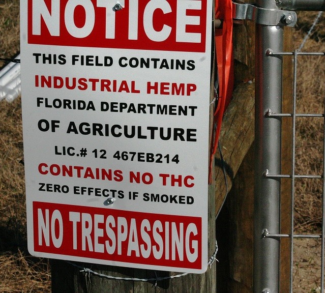 The second sign at the entrance to Central Flora Farms provides the business license number registered with the Florida Department of Agriculture and notes that industrial hemp is being grown on the property that contains no THC.