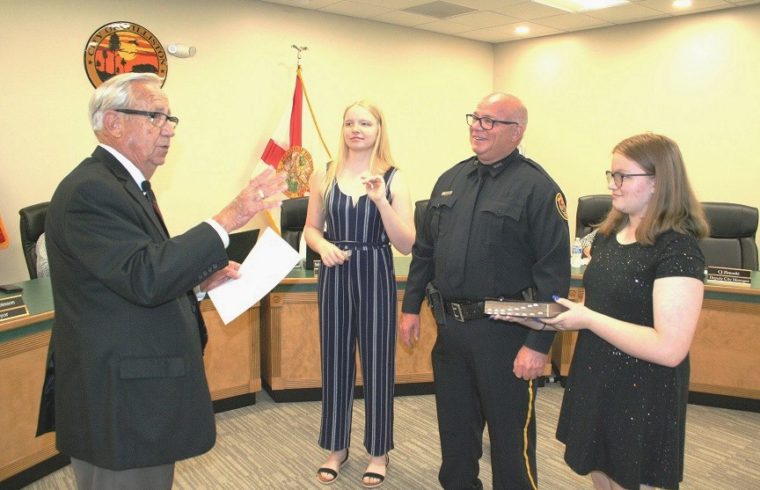 Williston native Jeff Holcomb takes the oath from Mayor Jerry Robinson as his daughters Delaney Holcomb on the left and Courtney Holcomb witness the event at Tuesday's city council meeting.