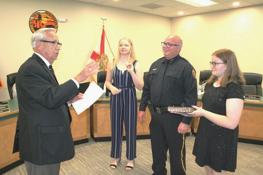 Williston native Jeff Holcomb takes the oath from Mayor Jerry Robinson as his daughters Delaney Holcomb on the left and Courtney Holcomb witness the event at Tuesday's city council meeting.