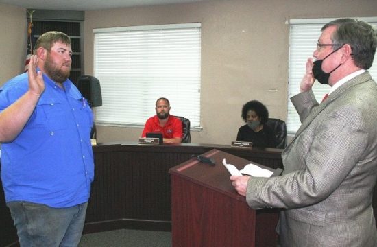 County Judge James T. Browning swears in Tyler Voorhees as a town councilman Monday. Voorhees replaces former Councilman Berlon Weeks. He will have to qualify for office in July in order to run in the September election.