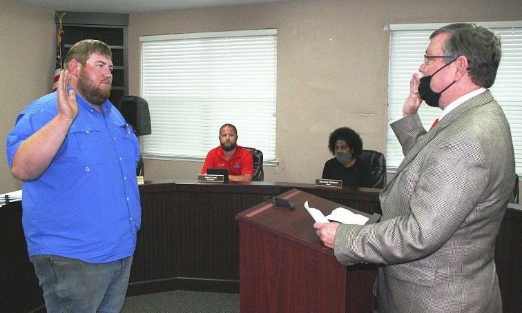 County Judge James T. Browning swears in Tyler Voorhees as a town councilman Monday. Voorhees replaces former Councilman Berlon Weeks. He will have to qualify for office in July in order to run in the September election.