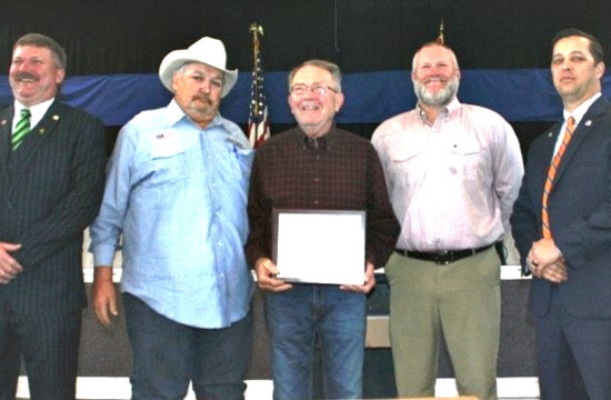 : Levy County Commissioners John Meeks, Mike Joyner, Rock Meeks and Matt Brooks honor Dr. Kenneth Schweibert. Commissioner Lilly Rooks isn't pictured because she participated remotely due to illness.