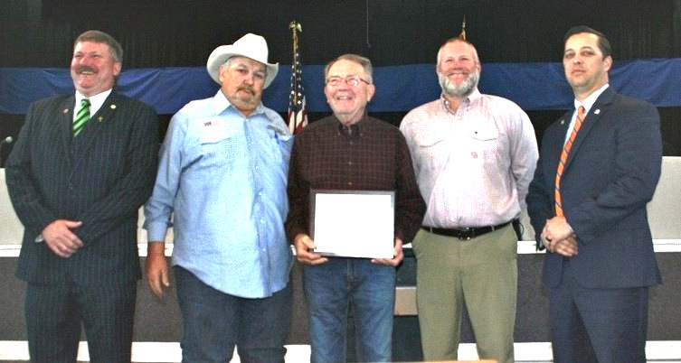 : Levy County Commissioners John Meeks, Mike Joyner, Rock Meeks and Matt Brooks honor Dr. Kenneth Schweibert. Commissioner Lilly Rooks isn't pictured because she participated remotely due to illness.