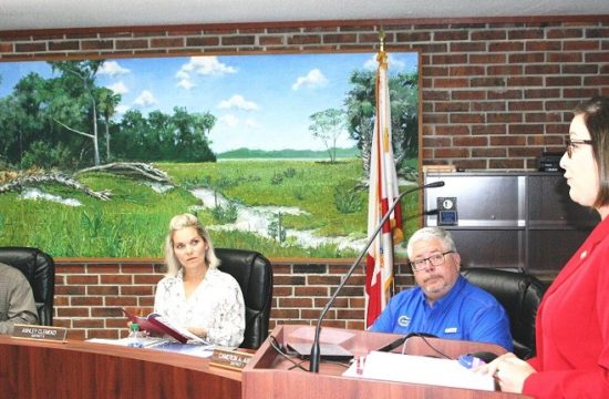 Supervisor of Elections Tammy Jones proposes the school board and county commission adopt identical district lines. Listening are School Board members Brad Etheridge, Ashley Clemenzi, and Chairman Cameron Asbell.