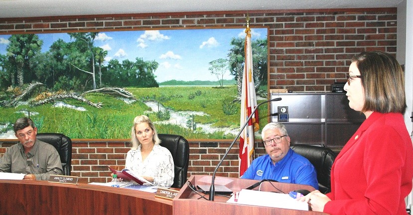 Supervisor of Elections Tammy Jones proposes the school board and county commission adopt identical district lines. Listening are School Board members Brad Etheridge, Ashley Clemenzi, and Chairman Cameron Asbell.