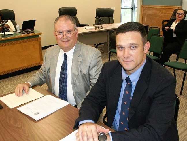 Attorneys Norm and Blake Fugate await the start of their interview. Blake Fugate would be Williston’s city attorney if the firm is hired on Tuesday.