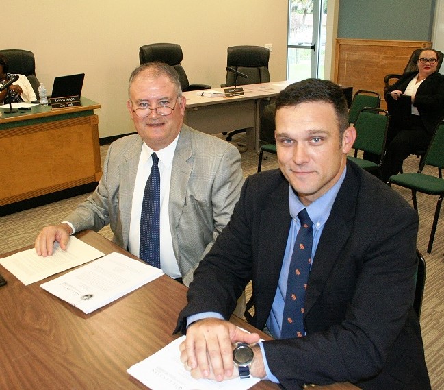 Attorneys Norm and Blake Fugate await the start of their interview. Blake Fugate would be Williston’s city attorney if the firm is hired on Tuesday.