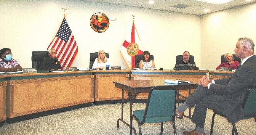 Senior attorney Scott Walker answers a question from Councilwoman Darfeness Hinds, far left, as Mayor Jerry Robinson, Council President Debra Jones, Councilwoman Marguerite Robinson, Councilman Michael Cox, and City Manager Jackie Gorman listen. Not shown is Elihu Ross.