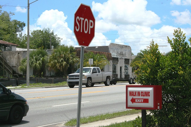 The Quick Care Clinic directly in front of the Episcopal Church property isn't far below the old pawn shop. The pawn shop can be seen between the two signs.