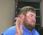 In this file photo, Bronson Councilman Tyler Voorhees takes the oath of office. At Monday's council meeting he proposed levying a fire tax.