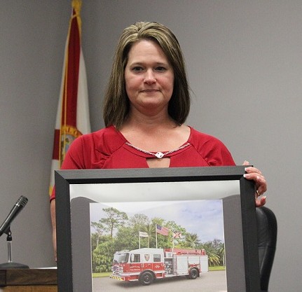 Deputy Clerk Belinda Wilkerson was honored by Fire Chief James Harris with this framed photo of the fire truck the city recently purchased. Wilkerson wrote a grant that made the purchase possible.